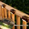 Brown Solar Step Lights on Deck Railing (Waterproof) Brown waterproof solar step lights installed on wooden deck railing, close-up view
