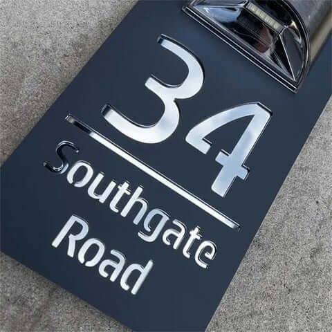 Close-up of personalised house number plaque 34 Southgate Road, 3D silver letters on black matte base
