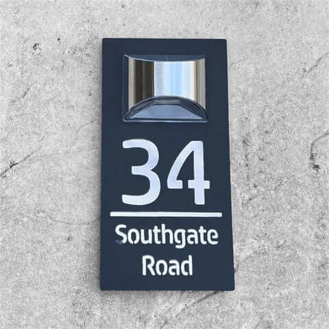 Black personalised LED house number plaque 34 Southgate Road, flat lay view on concrete surface