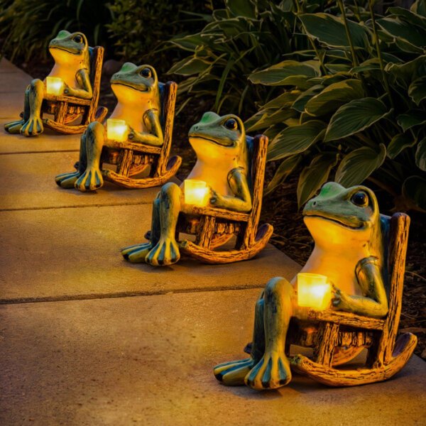 Multiple frog rocking chair solar lights lined up, garden pathway night decorative LED ornaments