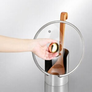 Multifunctional kitchen utensil rack – can store pot lids, spatulas and cutting boards. 3 Multi-purpose kitchen utensil rack lid spoon holder holding glass pot lid on kitchen worktop