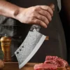 hand forged wolf head bone cleaver cutting raw beef meat wooden handle